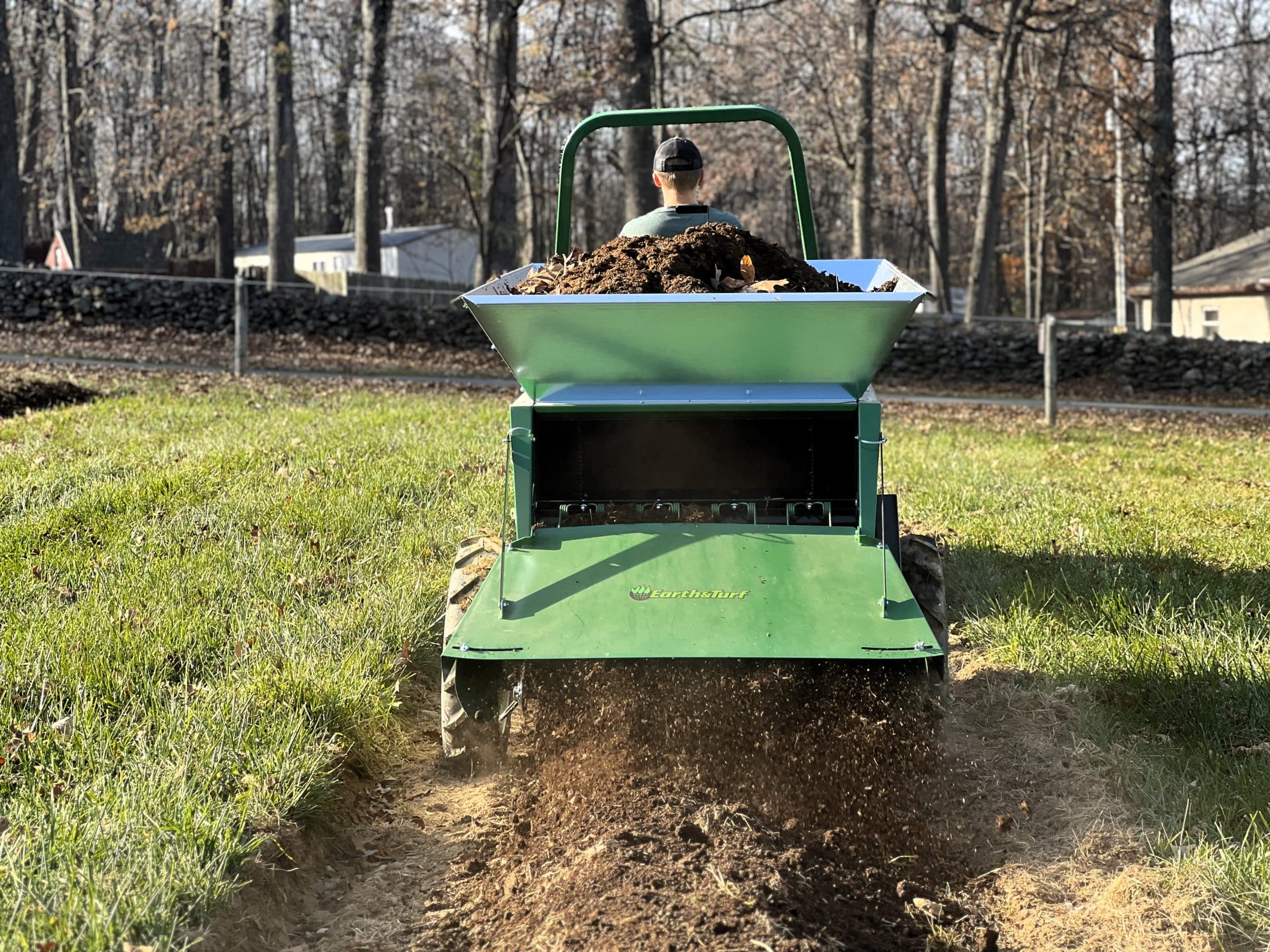 from behind view of the 320 compost spreader in action