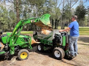 tractor loading a 415SP for a topdressing landscaper