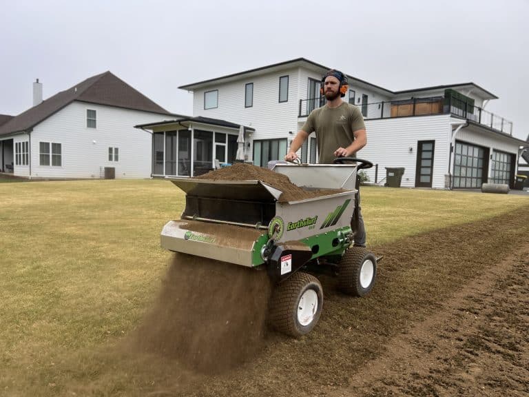 410 narrrow topdressing spreader from earth and turf spreading compost on a yard