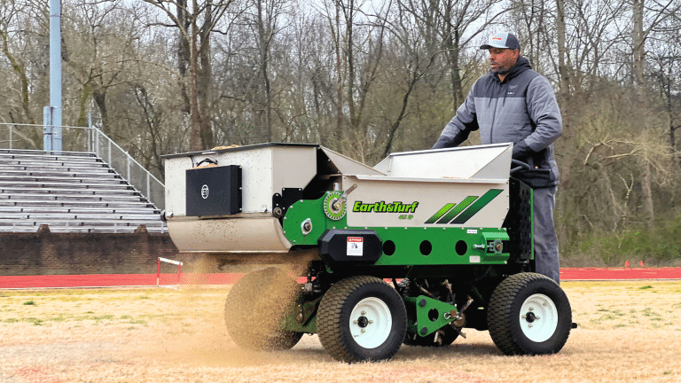 415 topdresser spreading sand on a sports field in Australia