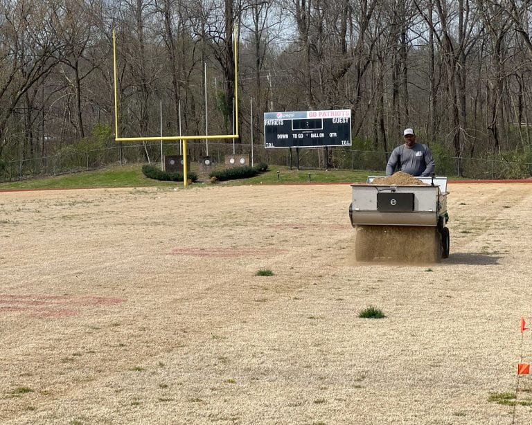 topdressing for athletic fields using a topdresser from earth and turf