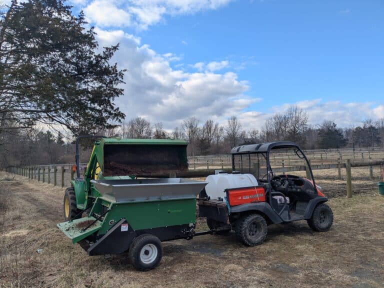 Multispread 220 being loaded up while being pulled by a Kubota Utility vehicle