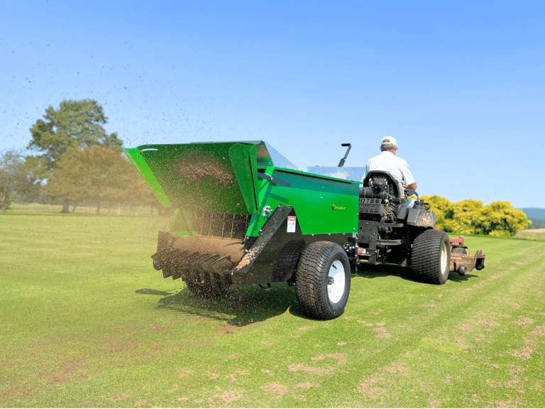 220 multispreader spreading sand on a golf course